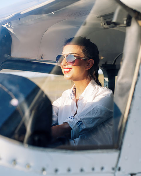 Smiling Latina Woman Pilot in training