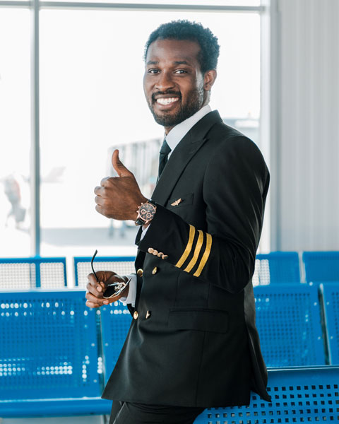 African American Airline Pilot giving thumbs up